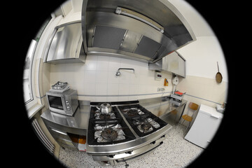 kitchen of a restaurant with the stove seen by a security camera