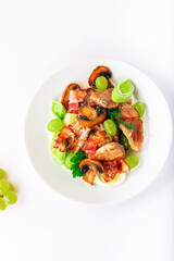 Pork with mushrooms, grapes, leek and parsley. High key. Selective focus.