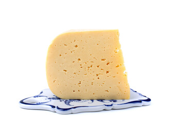 a piece of hard cheese on a ceramic tray, isolated white background, close-up,