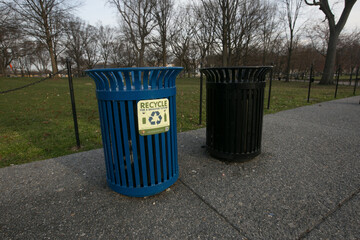 Blue urn with a recycling sign on a footpath