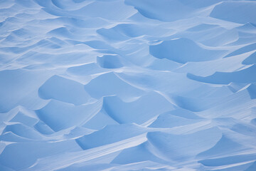 Snow texture. Wind sculpted patterns on snow surface. Wind in the tundra and in the mountains on...