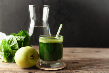 Healthy green smoothie on vintage wooden table. Fresh detox nutrient.