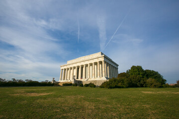 Lincoln Monument photographed against a background of green grass and blue sky. Lincoln Monument in...
