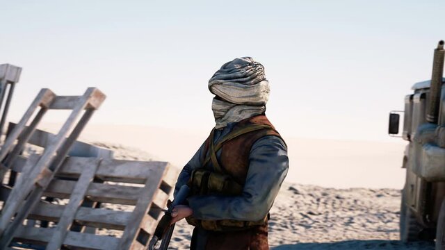 Man terrorist wearing a mask and holding a gun. East desert landscape. military headquarters, terrorist base.