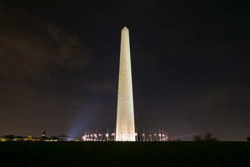 Fototapeta premium Washington Monument at night with lowered American flags around