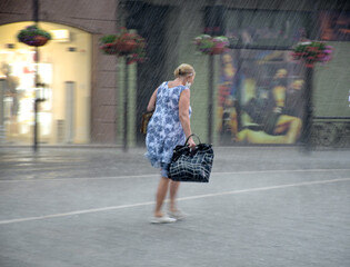 Woman walking down the street in a rainy day