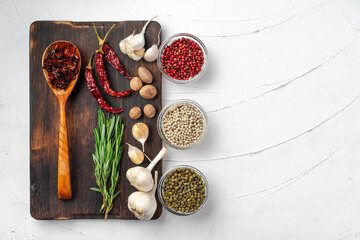 Red chili peppers and other spices on white textured background, top view