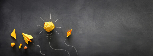 Education concept image. Creative idea and innovation. Crumpled paper as light bulb metaphor over...