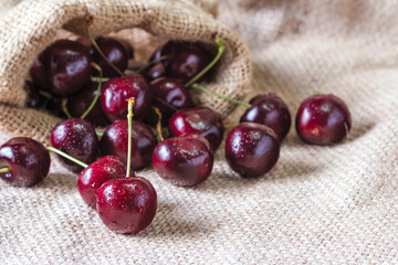 Red cherry with water drop on the sackcloth