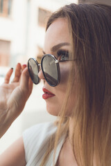 facial portrait of a beautiful white woman in black sunglasses. High quality photo