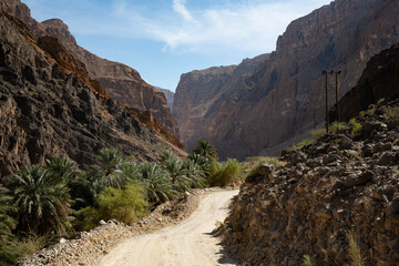 Gravel road and mountain landscape in Oman's Wadi Arbiyeen
