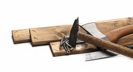 Tools for manual labor, ax, hammer and nails with wooden planks isolated on white background