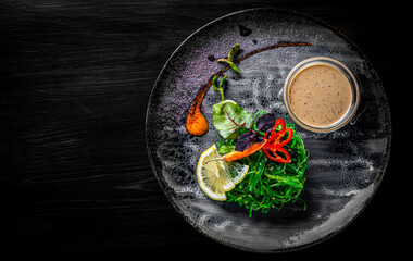 Chuka Seaweed Salad in plate on black wooden table background