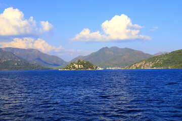 Picturesque sea view in Turkey, near Bodrum and Marmaris, water waves. Mountains and hills around the bay, summer resort landscape