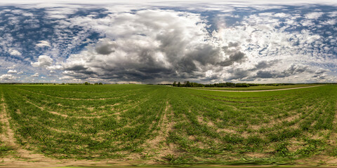 full seamless spherical hdri panorama 360 degrees angle view on among fields in summer day with awesome clouds before storm in equirectangular projection, ready for VR AR virtual reality content