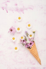 spring flowers in ice cream cone on a table with copy space
