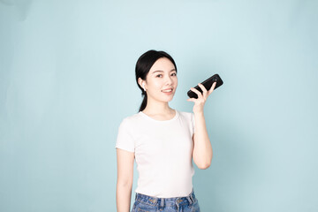 A Young Chinese Woman In Front of Blue Background