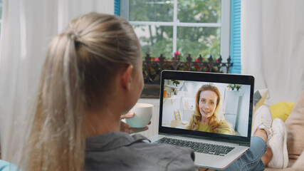 Millennial girl talk on video call with mature mother