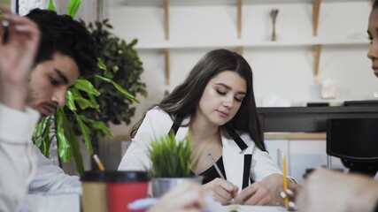 Young team working on new project. Group people writing something