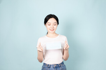 A Young Chinese Woman In Front of Blue Background