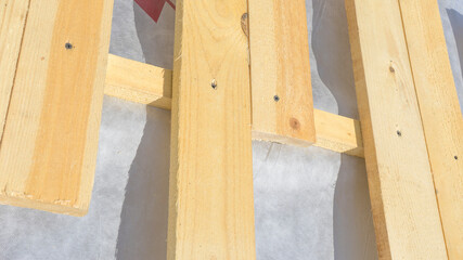 installation of wooden rafters during the construction of the roof frame, a waterproofing film is stretched on top