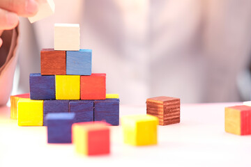 wooden cube block on table background and business concept growth success process and plan growth and increase of positive indicators in his business