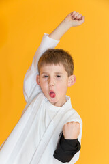 Little boy as a karate fighter. Funny faces.