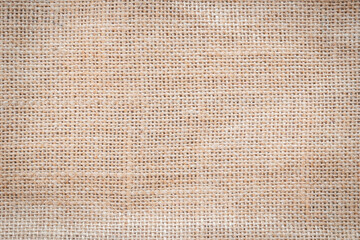 Jute hessian sackcloth woven burlap texture pattern background in old aged yellow beige cream gold brown color