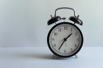 clock with alarm clock on white background with place for inscription. time management, business investment, planning