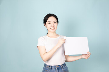 A Young Chinese Woman In Front of Blue Background