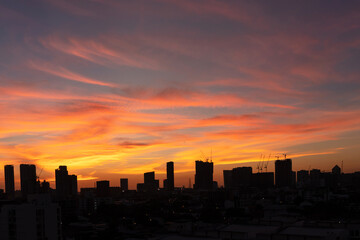 Fototapeta na wymiar Silhouette of skyscraper city landscape background with beautiful sunset sky.