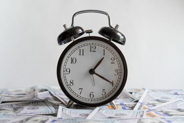 Alarm clock on money banknotes Dollars, concept of business planning and finance. Usurer, credit concept. Time for quick money.Time management, business investment, planning