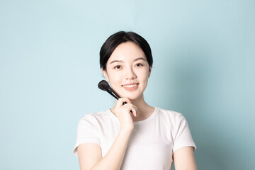 A Young Chinese Woman In Front of Blue Background