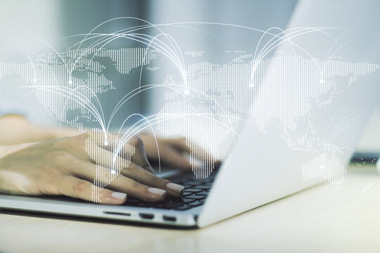 Double exposure of abstract digital world map with connections and hands typing on laptop on background, research and strategy concept