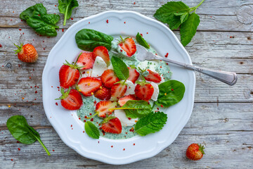 A healthy and delicious salad made from fresh strawberries and mozzarella.
