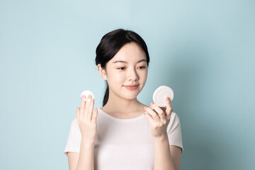 A Young Chinese Woman In Front of Blue Background