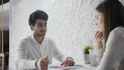 Two Economic Analytics Work, They Discuss Statistics, Graphs and Data