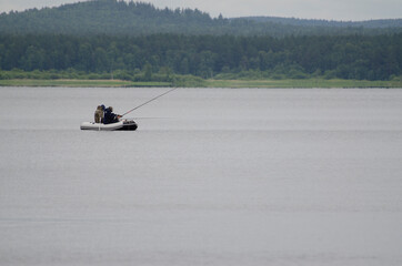 Fishermen on a boat fishing for fishing