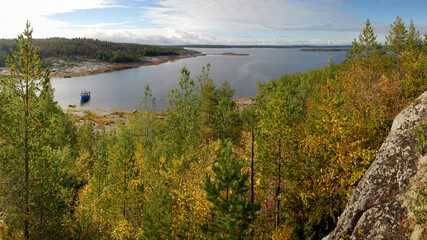 Karelian landscape. Motor boat by Sidorov island. Kandalaksha Gulf of White Sea. Republic of Karelia, Russia.