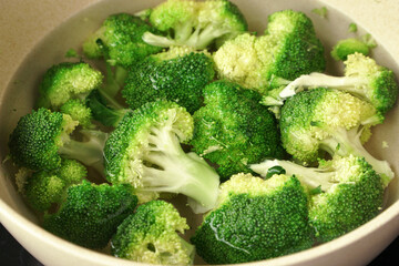 Fresh green broccoli in a bowl of water