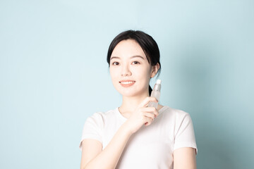 A Young Chinese woman in front of a blue background