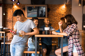 A man checking his phone beside his friendship