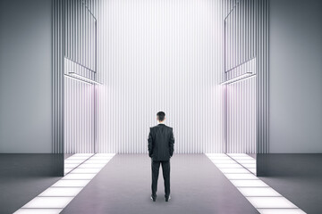 Businessman standing in contemporary gallery white interior