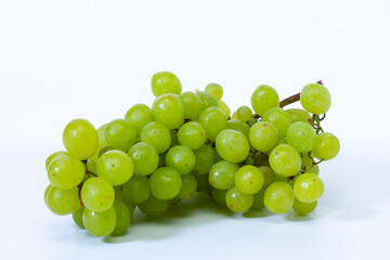A bunch of grapes close-up on a light background.