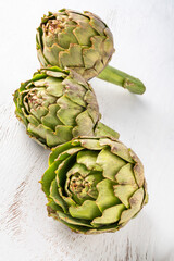 Obraz premium fresh and ripe artichokes on a wooden table