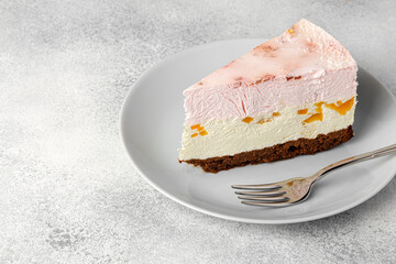 Piece of cheese cake on white plate on table