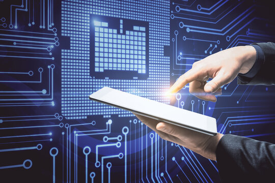 Businessman hands using digital tablet with circuit hologram.