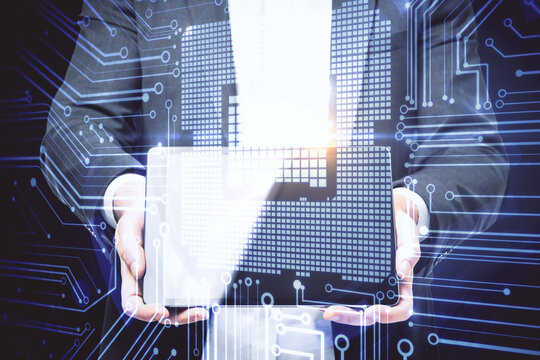 Businessman using tablet with circuit hologram.
