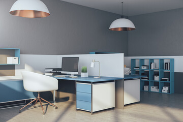 Modern office interior with computers on table and shelf with books.