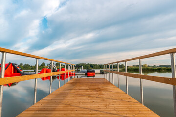 Fototapeta premium Empty wooden pier and water bouncy park
